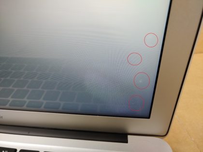 There is a few tiny very faint pressure marks in the lower right cornre of the screen (View image 9). There is a thin faint wear spot from the keyboard