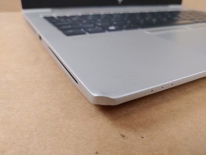 **NO POWER ADAPTER**  The corner of the lid has a cosmetic blemish causing the bezel to seperate a tiny bit (View image 8). The corner of the palmrest also has a cosmetic blemish (View image 9). Tested and Working as it should. Clean install of Windows 11 Pro Operating system. May have a few minor cosmetic scratches/scuffs. For your help