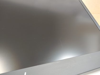 There is a thin scratch at the bottom of the screen (View image 9). There is a little paint flaked off by the space bar and between some keys (View image 10). 2 Rubber feet are missing on the bottom
