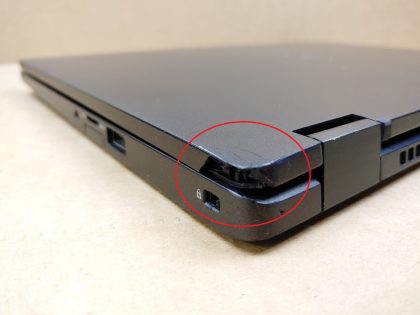 There is a piece of plastic broke off by the SC slot (View image 9). The back corner of the lid has a piece of plastic broke off as well (View image 10). The screw on the bottom just spins